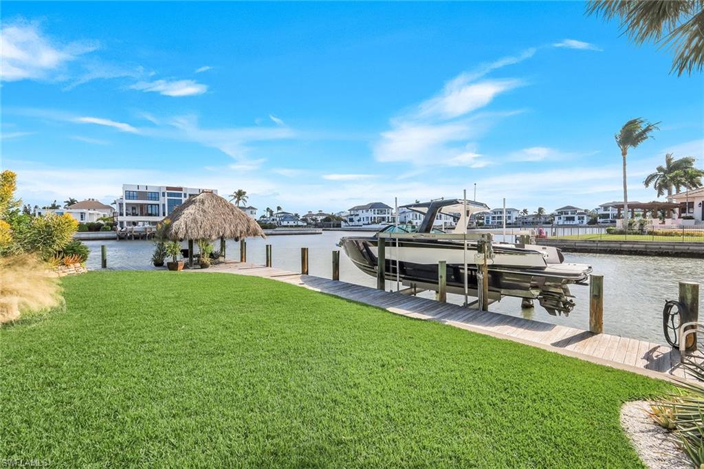 290 Channel Drive Naples, FL 34108 - Photo 49 of 49 a view of a house with a yard and sitting area