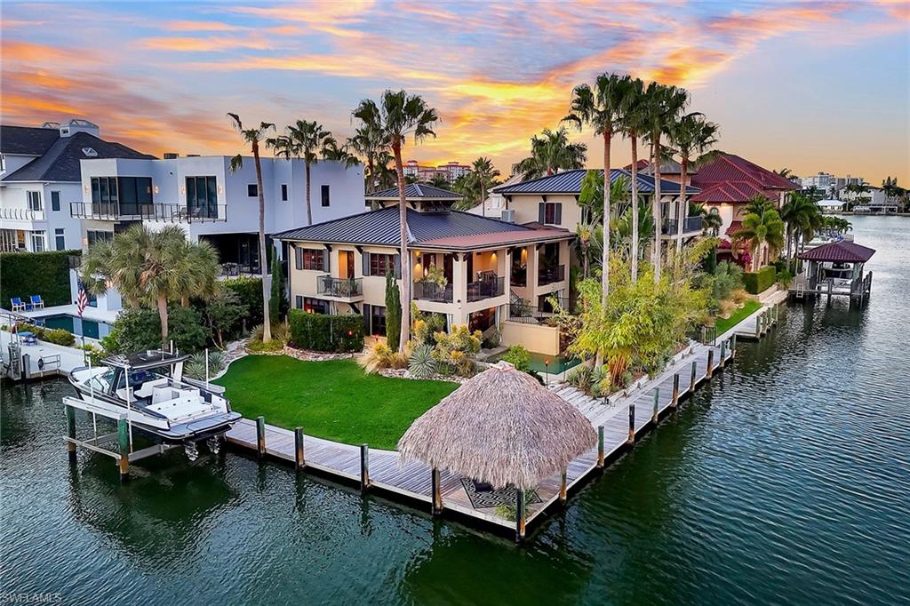 290 Channel Drive Naples, FL 34108 - Photo 7 of 49 a view of a chairs and table in backyard of the house