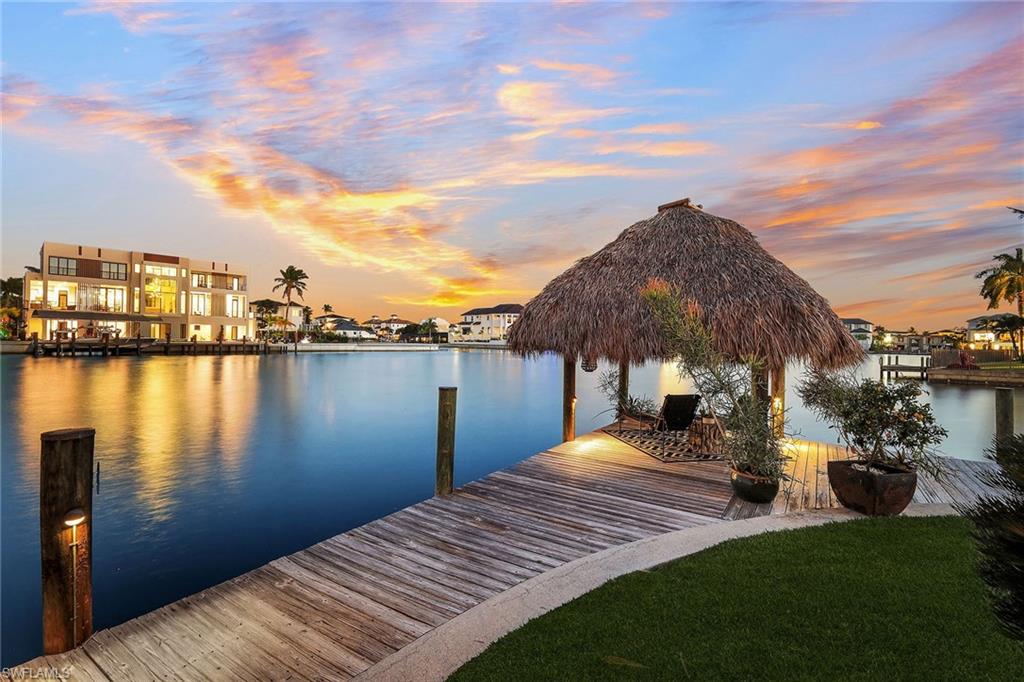 290 Channel Drive Naples, FL 34108 - Photo 8 of 49 a view of a lake with a house