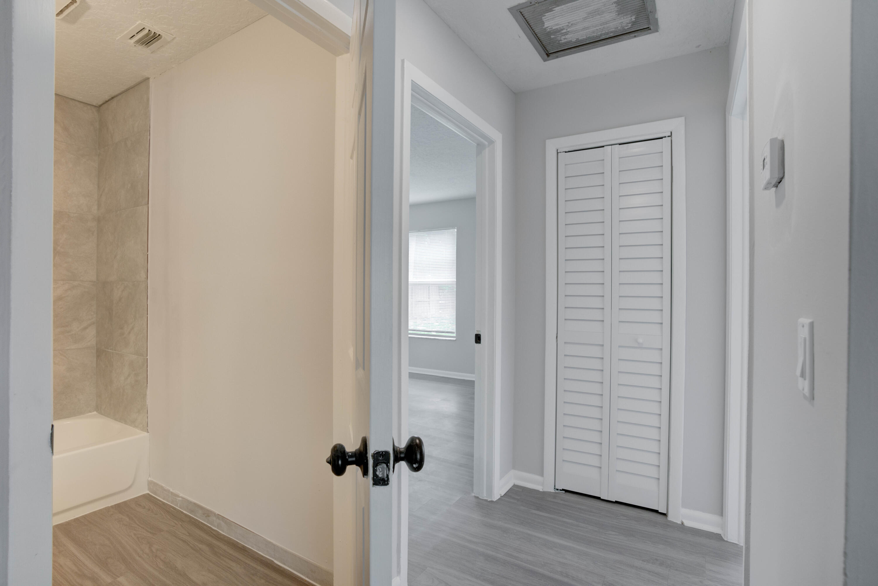 6567 Jupiter Gardens Boulevard, Unit 7 Jupiter, FL 33458 - Photo 16 of 20 a view of a hallway with wooden floor