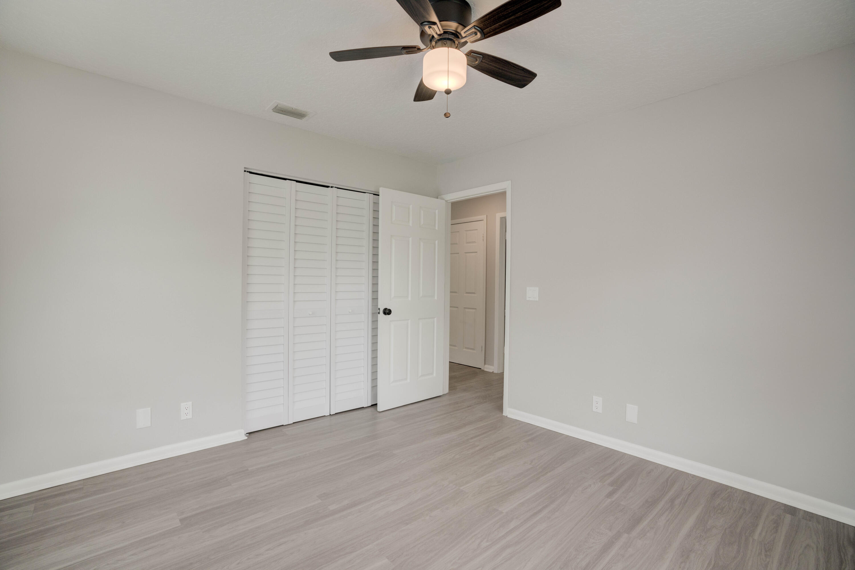 6567 Jupiter Gardens Boulevard, Unit 7 Jupiter, FL 33458 - Photo 19 of 20 a view of an empty room and wooden floor