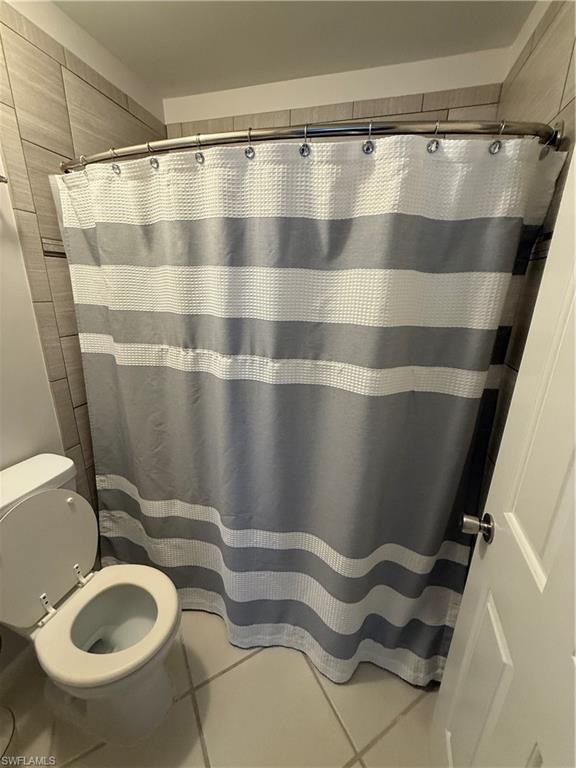 760 Augusta Boulevard, Unit D204 Naples, FL 34113 - Photo 27 of 32 a bathroom with a sink and a mirror