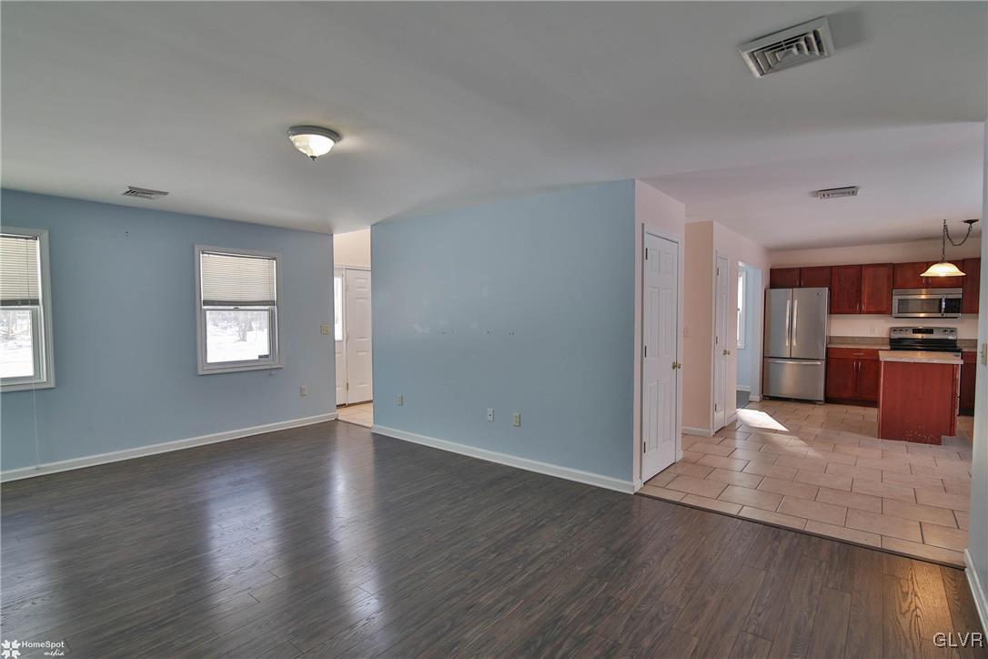 185 Sunset Road East Stroudsburg, PA 18302 - Photo 11 of 49 an empty room with wooden floor and windows