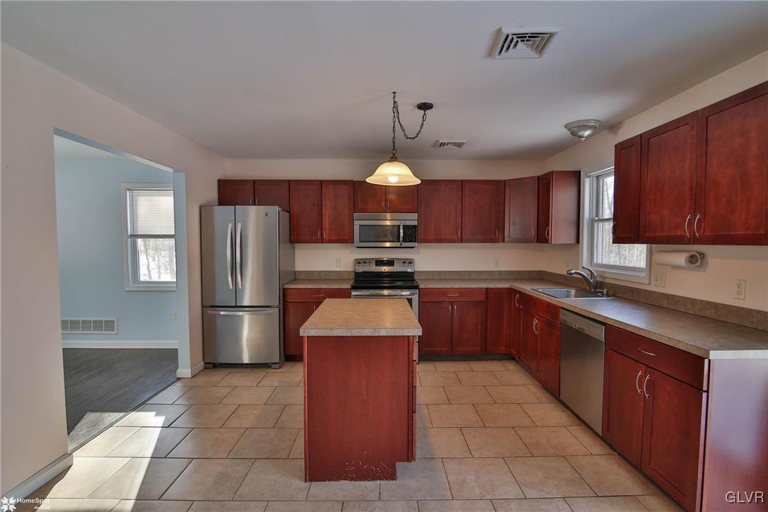 185 Sunset Road East Stroudsburg, PA 18302 - Photo 13 of 49 a kitchen with stainless steel appliances granite countertop a refrigerator a stove a sink dishwasher and a refrigerator