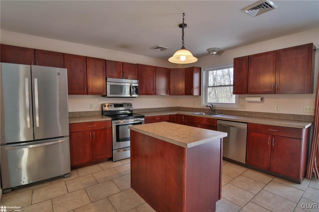 185 Sunset Road East Stroudsburg, PA 18302 - Photo 14 of 49 a kitchen with stainless steel appliances granite countertop wooden cabinets a stove top oven a sink and dishwasher