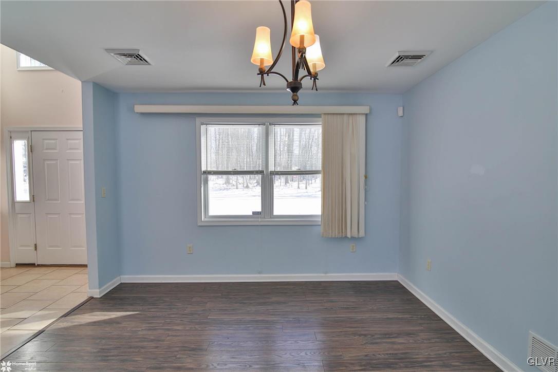 185 Sunset Road East Stroudsburg, PA 18302 - Photo 19 of 49 a view of an empty room with wooden floor and fan