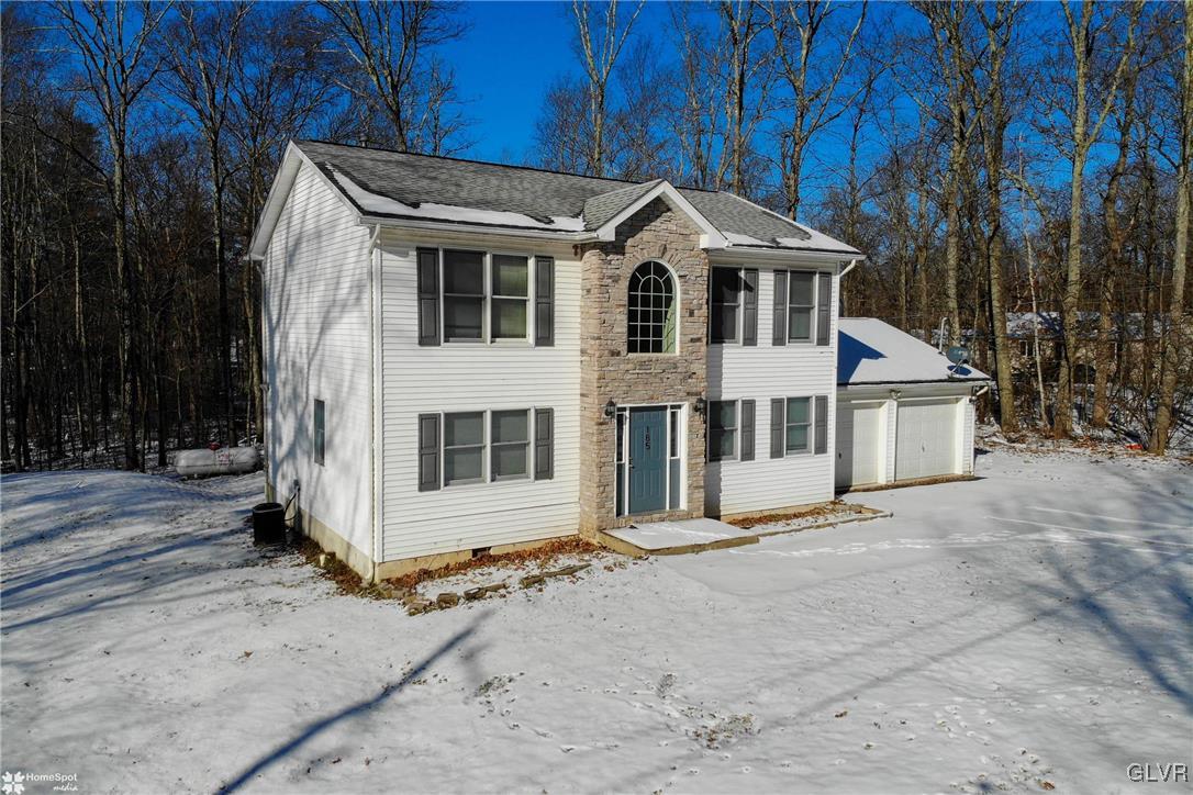 185 Sunset Road East Stroudsburg, PA 18302 - Photo 2 of 49 a front view of a house with a yard and garage