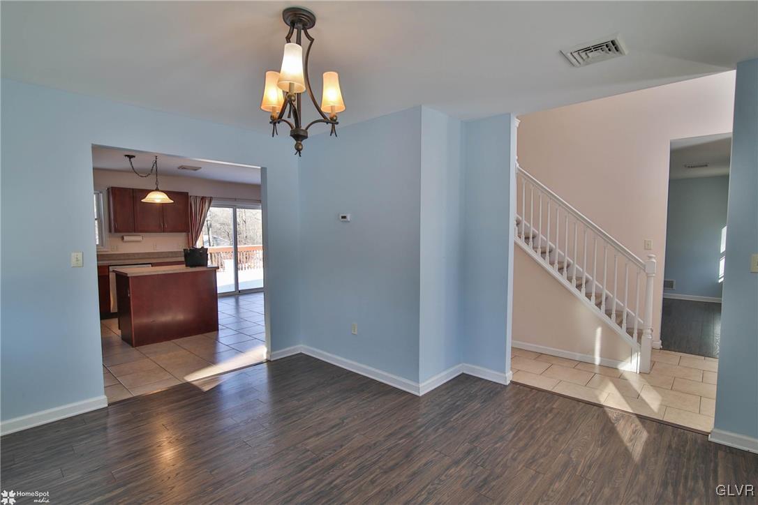 185 Sunset Road East Stroudsburg, PA 18302 - Photo 22 of 49 a view of a room with wooden floor staircase and a kitchen