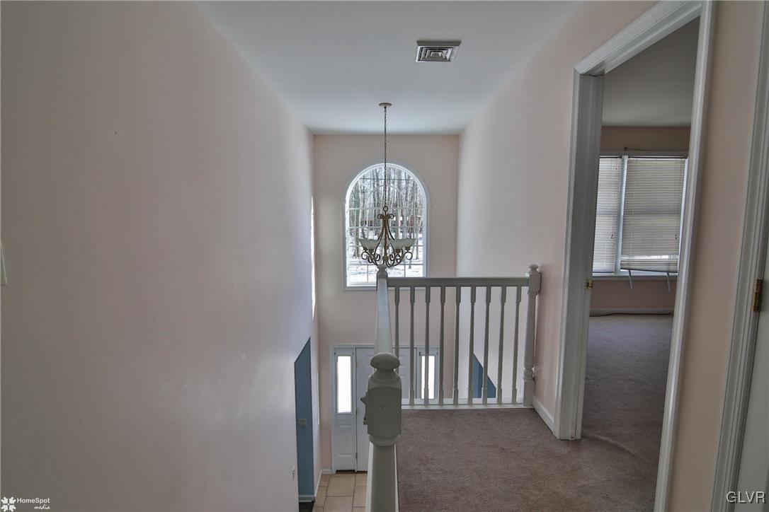 185 Sunset Road East Stroudsburg, PA 18302 - Photo 27 of 49 a view of a hallway to dining room with wooden floor