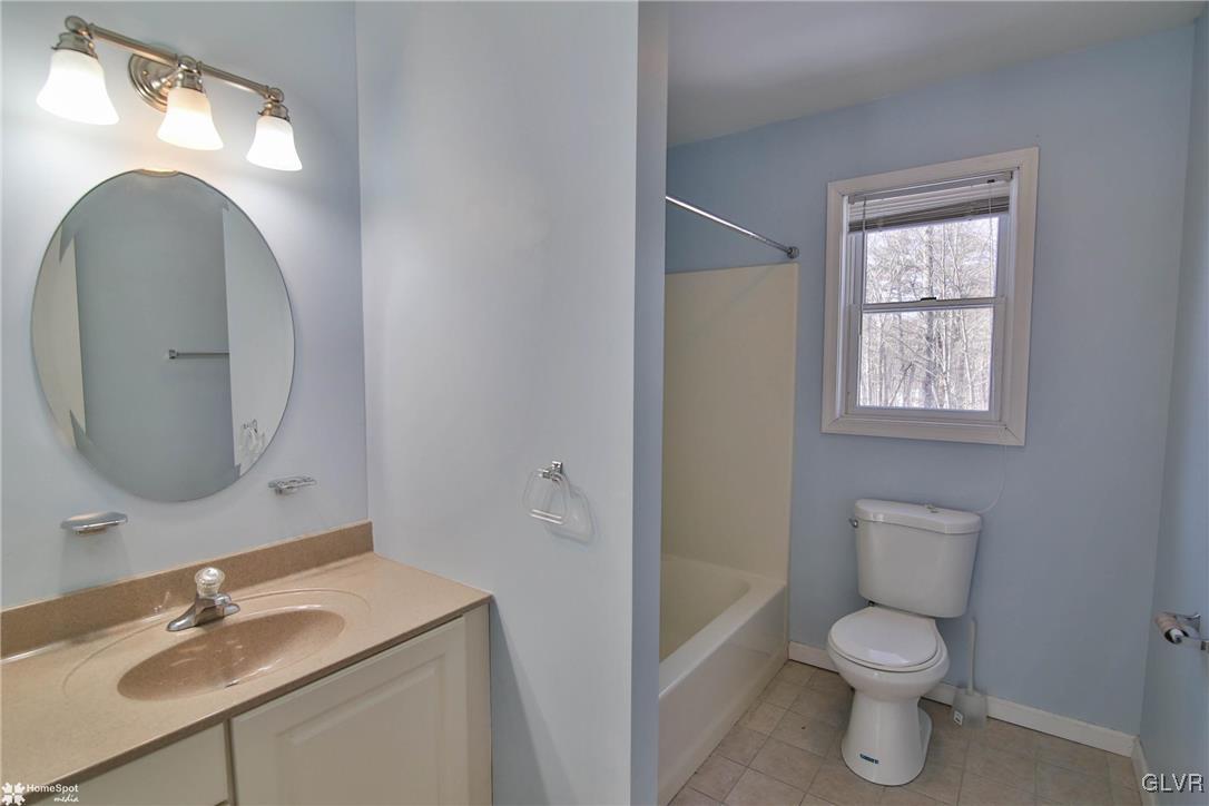 185 Sunset Road East Stroudsburg, PA 18302 - Photo 30 of 49 a bathroom with a toilet a sink and mirror