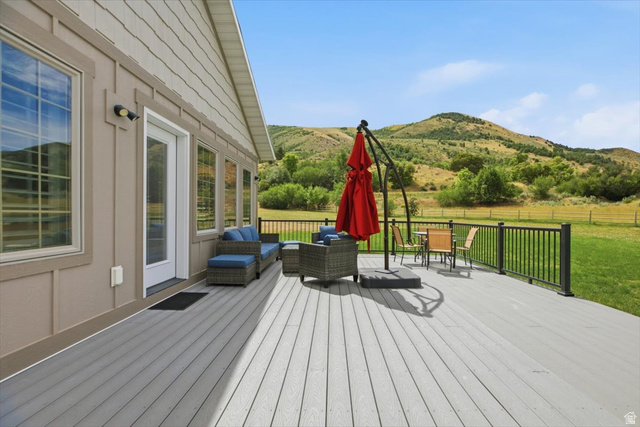 3123 East Riverdale Road Preston, ID 83263 - Photo 27 of 52 Spacious outdoor deck featuring composite decking, black metal railing, and direct access to the interior through a glass-paneled door