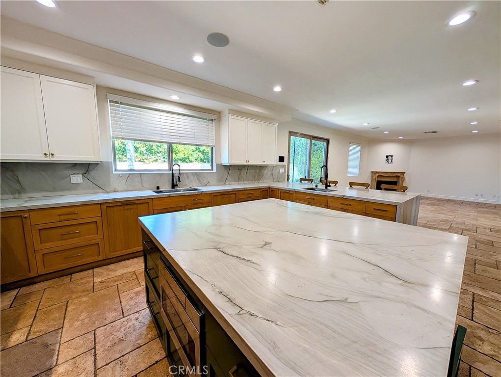 16659 Addison Street Encino, CA 91436 - Photo 19 of 48 a kitchen with stainless steel appliances granite countertop a sink and cabinets