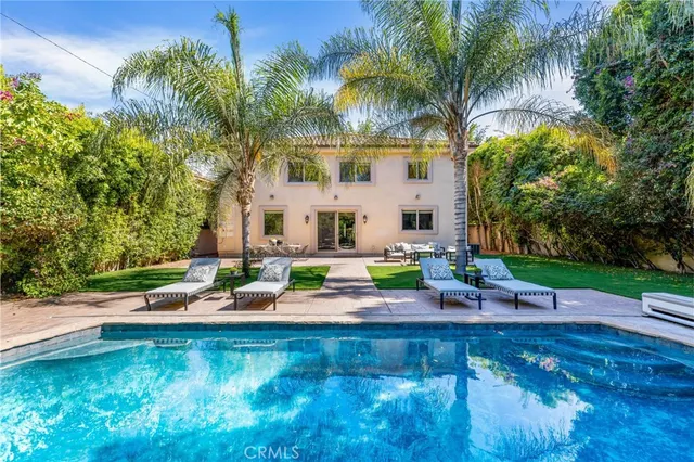 a view of swimming pool with outdoor seating and trees