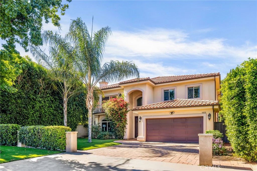 16659 Addison Street Encino, CA 91436 - Photo 3 of 48 a front view of a house with a garden
