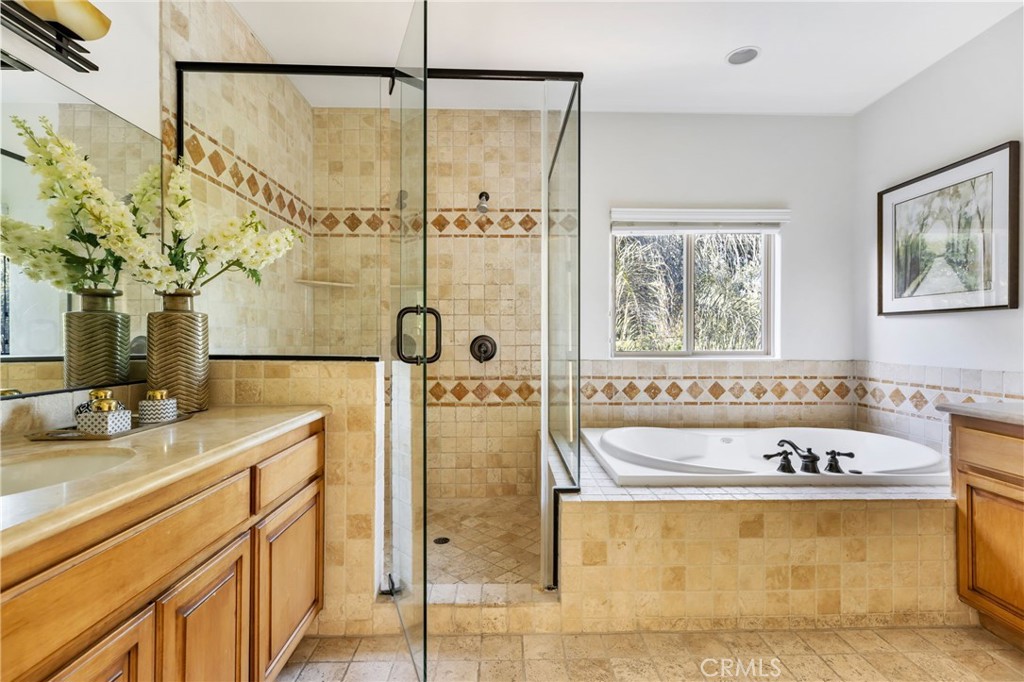 16659 Addison Street Encino, CA 91436 - Photo 36 of 48 a bathroom with a tub sink and mirror
