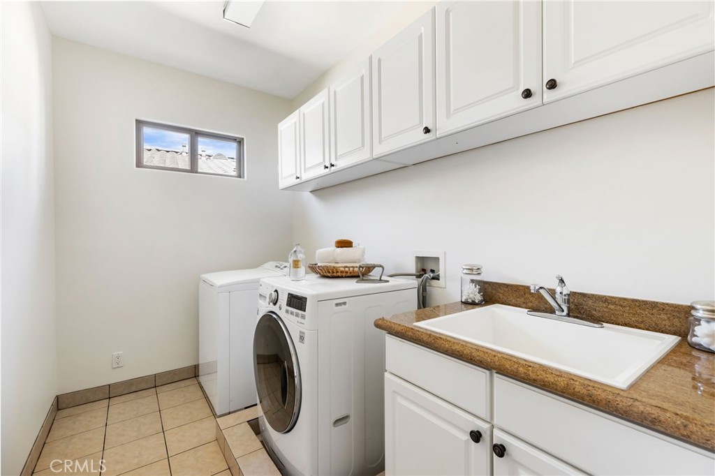 16659 Addison Street Encino, CA 91436 - Photo 38 of 48 a utility room with dryer and washer