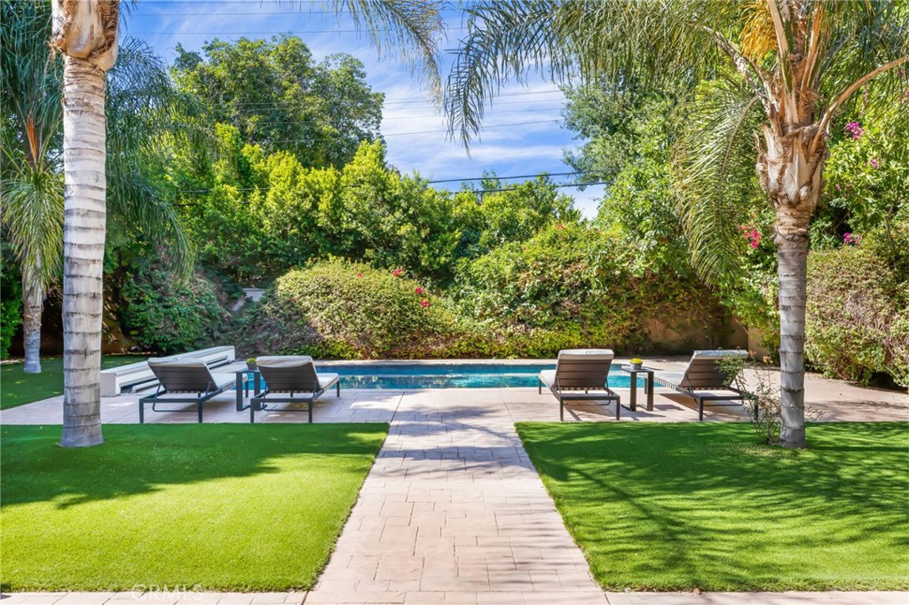 16659 Addison Street Encino, CA 91436 - Photo 39 of 48 a view of house with garden and a bench