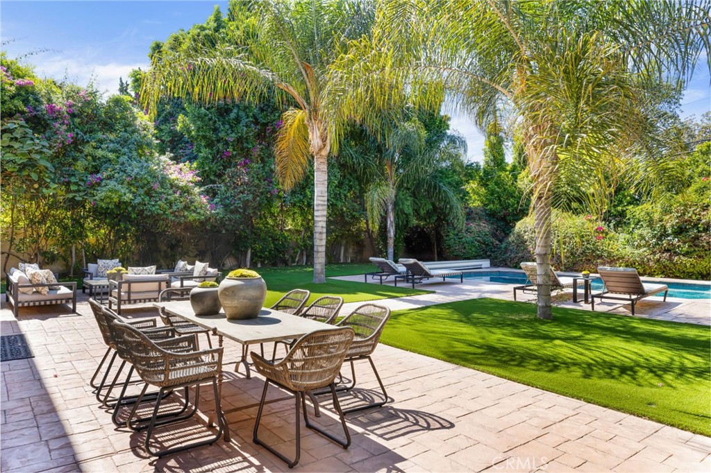 16659 Addison Street Encino, CA 91436 - Photo 40 of 48 a view of a chairs and table in backyard of the house