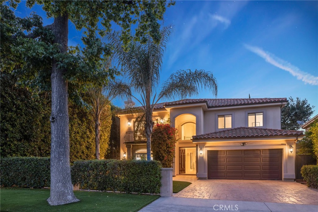 16659 Addison Street Encino, CA 91436 - Photo 4 of 48 a front view of a house with a garden