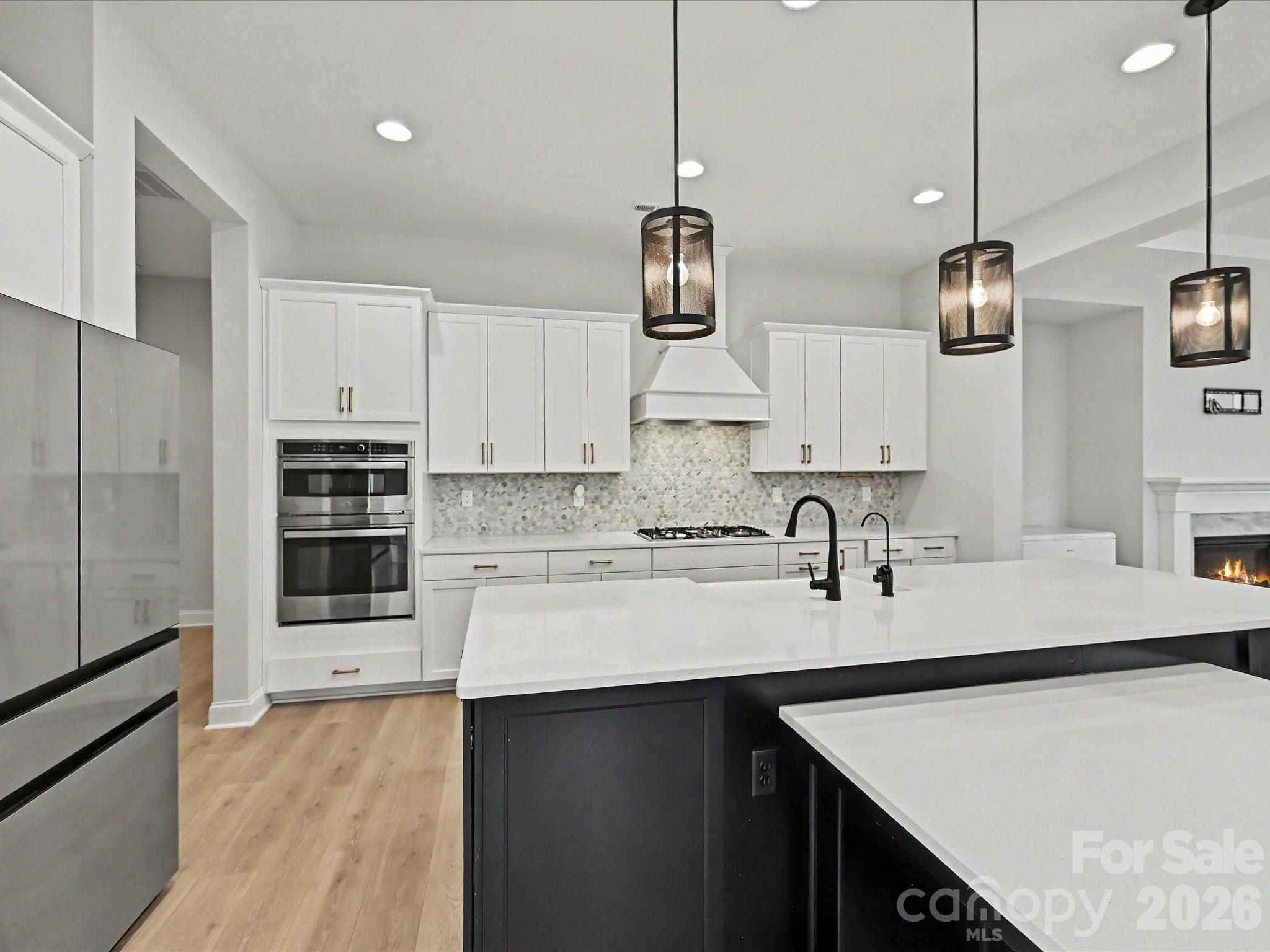 315 West Waterlynn Road Mooresville, NC 28117 - Photo 14 of 46 a kitchen with stainless steel appliances a sink a stove a refrigerator a center island and cabinets