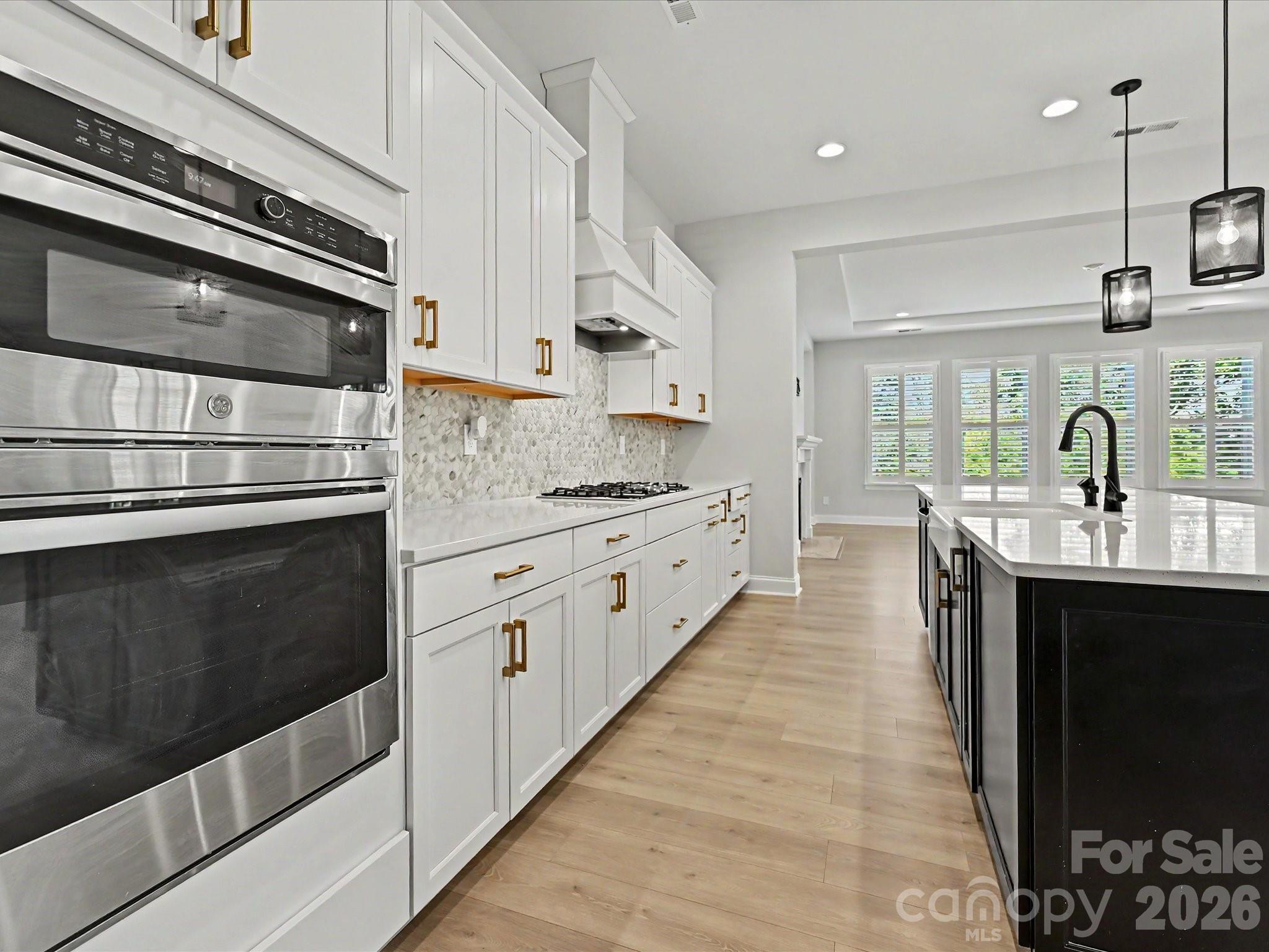 315 West Waterlynn Road Mooresville, NC 28117 - Photo 15 of 46 a kitchen with stainless steel appliances kitchen island granite countertop a stove a sink and a microwave