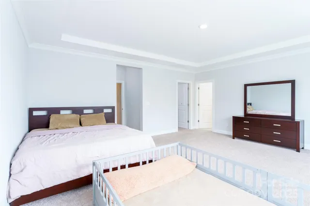 a bedroom with a bed and a dresser