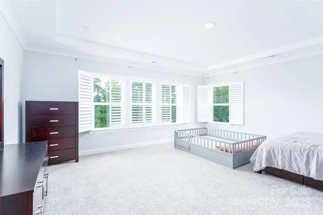 a spacious bedroom with a bed and a couch