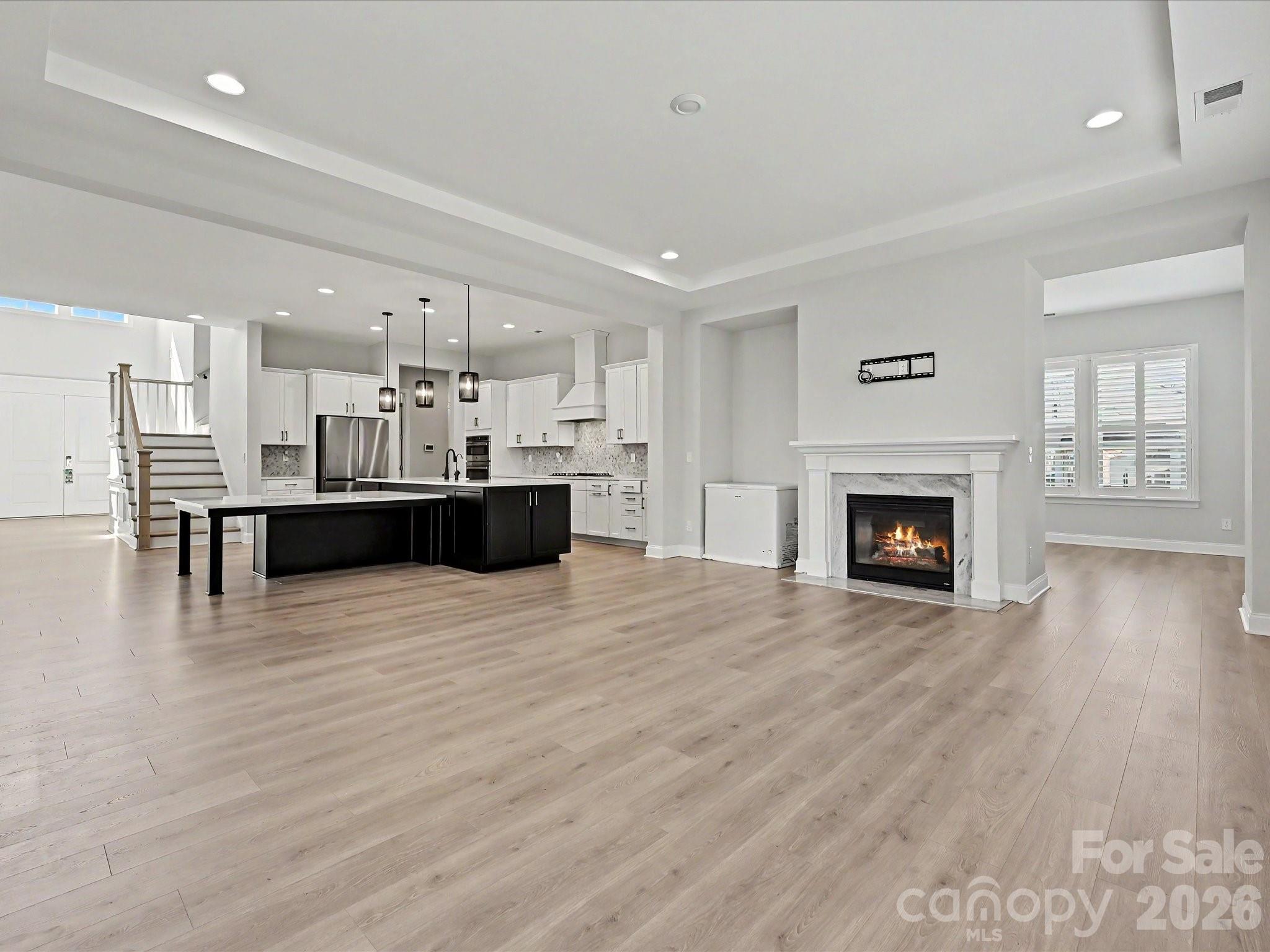 315 West Waterlynn Road Mooresville, NC 28117 - Photo 19 of 46 a large kitchen with cabinets wooden floor and a fireplace