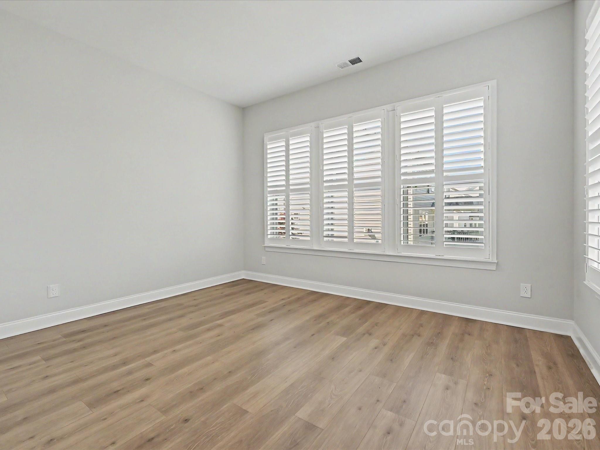 315 West Waterlynn Road Mooresville, NC 28117 - Photo 22 of 46 a view of an empty room with wooden floor and a window
