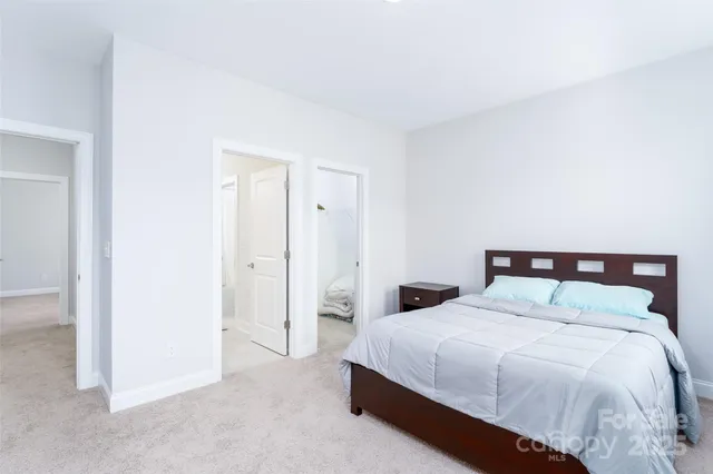 a large bed sitting in a bedroom and a table