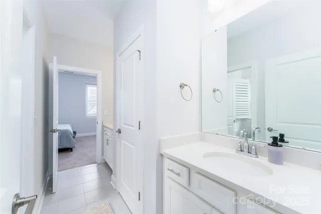 a spacious bathroom with a granite countertop sink and a mirror