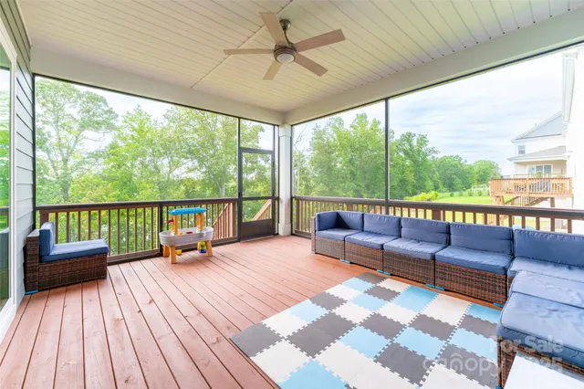 a balcony with furniture and a garden view
