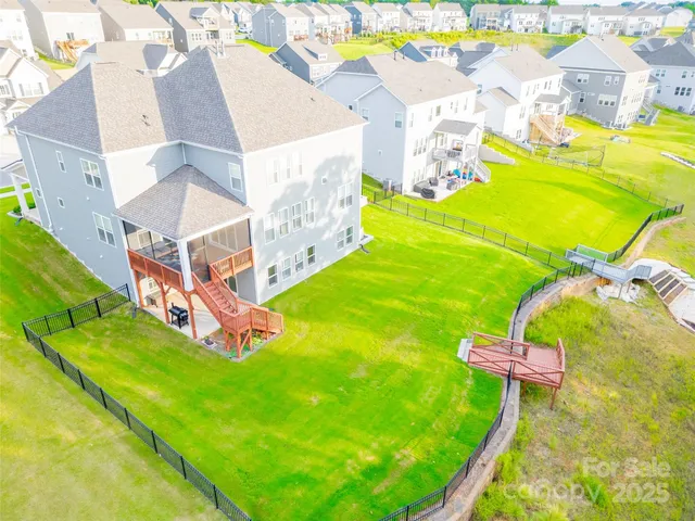 an aerial view of a house with a swimming pool