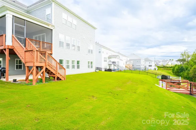 a view of a porch with furniture and a yard