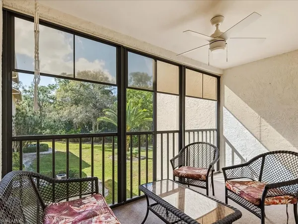 a balcony with a couch and chairs