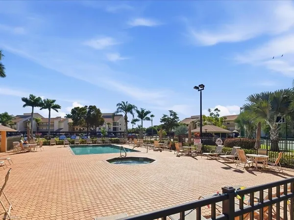 a view of tall buildings and swimming pool with seating area