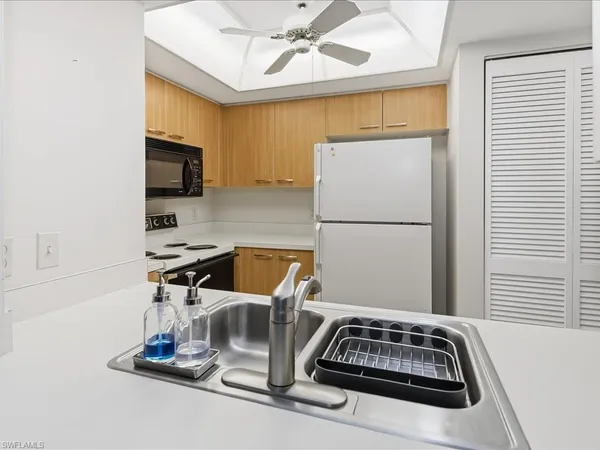 a kitchen with a sink appliances and cabinets