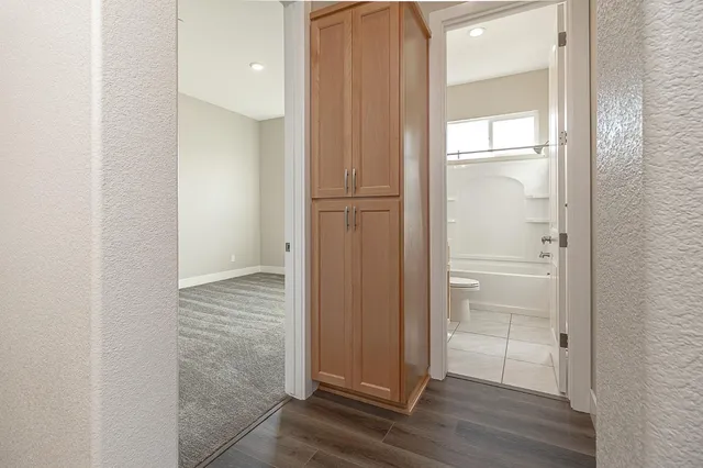 a view of a hallway with wooden floor
