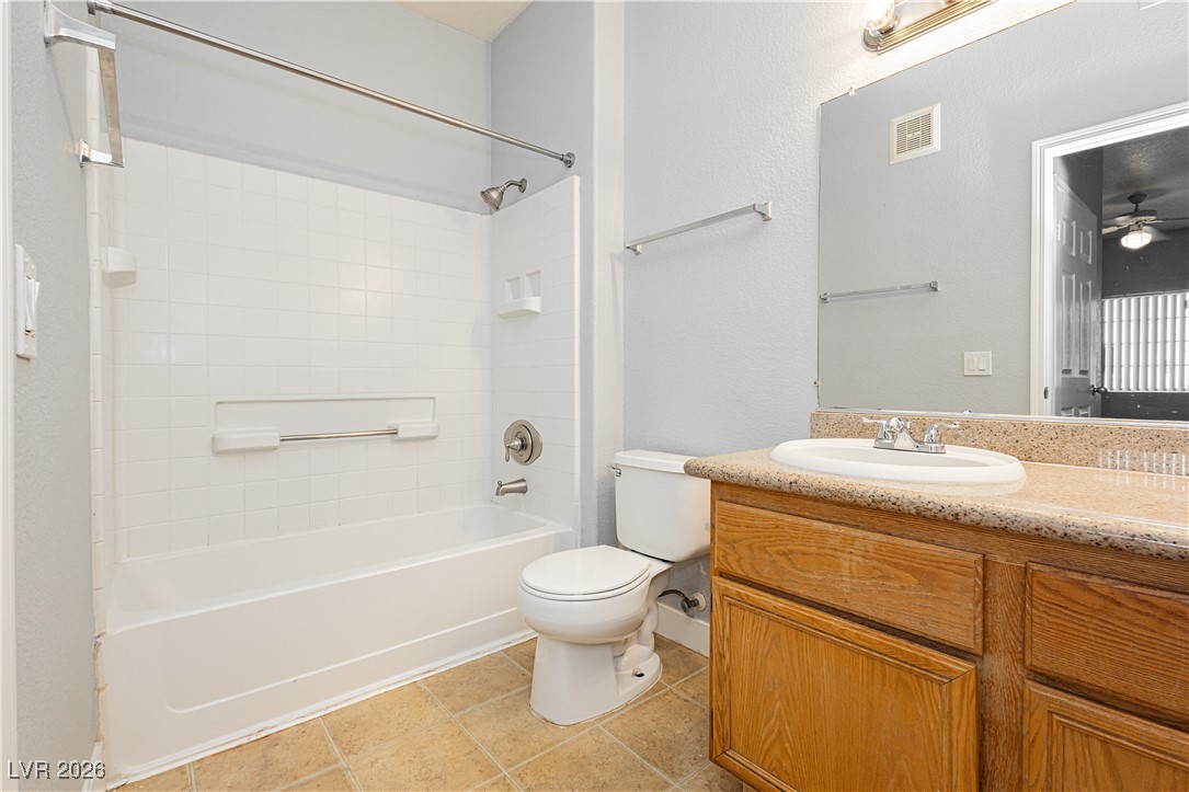 3318 North Decatur Boulevard, Unit 1082 Las Vegas, NV 89130 - Photo 24 of 25 Full bathroom featuring vanity, tub / shower combination, light tile patterned floors, and a ceiling fan