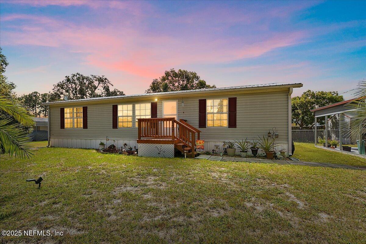 107 Indiana Street Crescent City, FL 32112 - Photo 1 of 19 a view of a house with backyard porch and garden