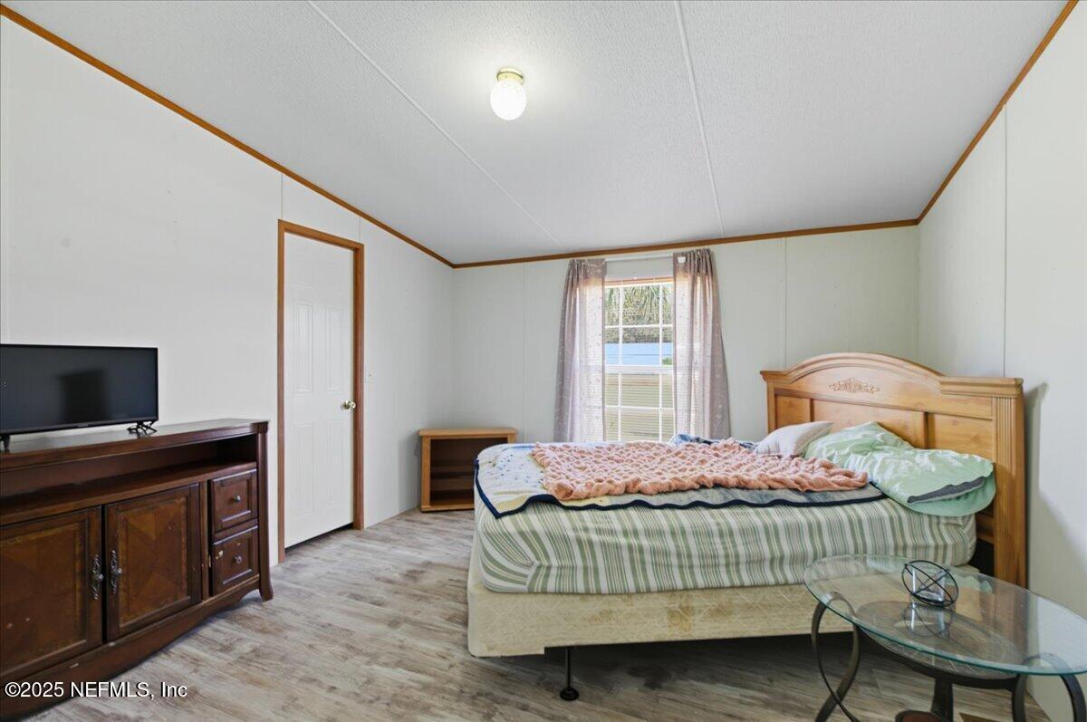 107 Indiana Street Crescent City, FL 32112 - Photo 11 of 19 a bedroom with a bed and a flat screen tv