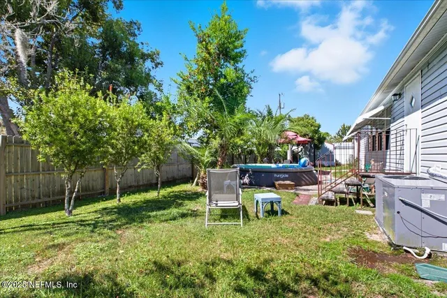 a view of a chair and table in the garden