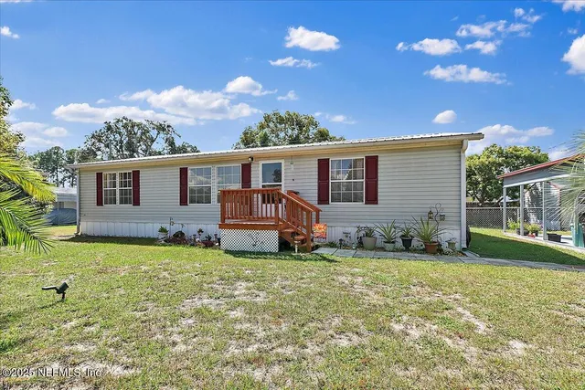 a backyard of a house with table and chairs
