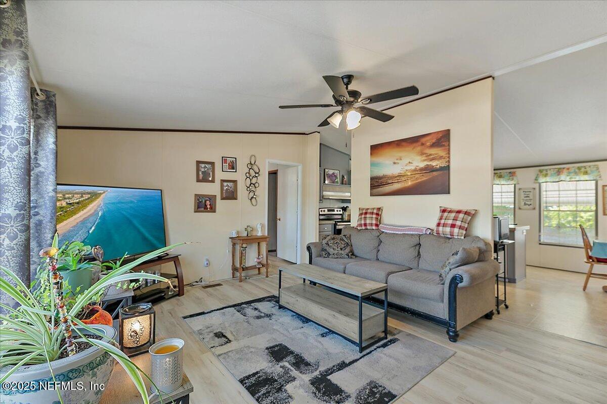 107 Indiana Street Crescent City, FL 32112 - Photo 3 of 19 a living room with furniture and a flat screen tv