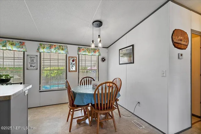 a view of a dining room with furniture window and outside view