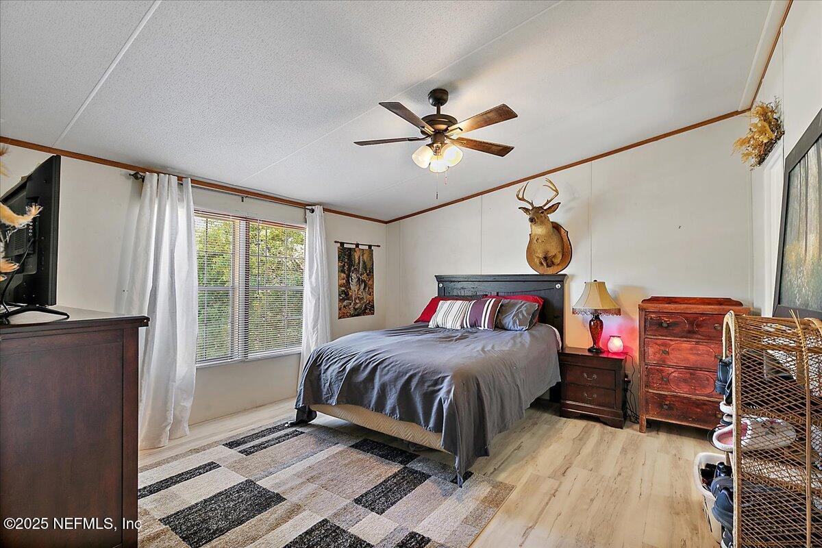 107 Indiana Street Crescent City, FL 32112 - Photo 8 of 19 a bedroom with a bed dresser and a window