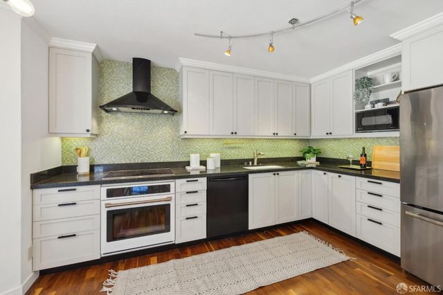 a kitchen with a stove oven and white cabinets