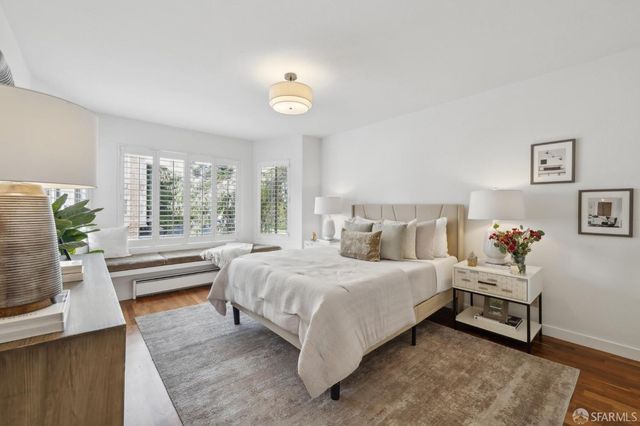 a bedroom with a bed and a large window