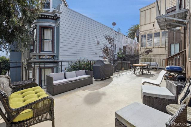a view of a patio with couches chairs and a potted plant