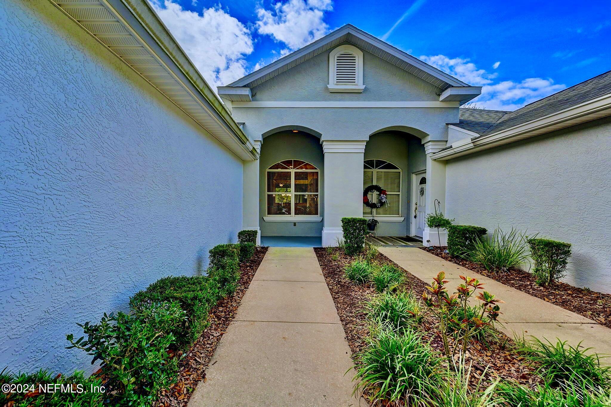1308 Asher Court Ormond Beach, FL 32174 - Photo 5 of 40 a front view of a house with garden